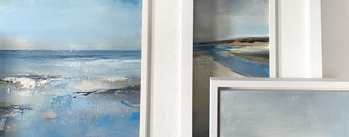 ©Tracey Ross Artist- a display of a group of framed paintings for sale in the shop.