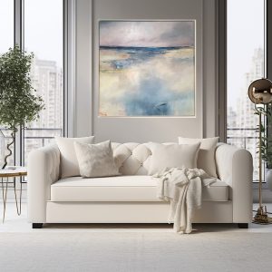 Room Interior with a seascape painting by artist Tracey Ross above a cream sofa.